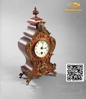 Ornate antique mantel clock with carved wood and gilded decorative accents.