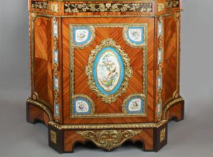 Antique French-style cabinet with intricate marquetry, porcelain plaques, and gilded bronze details. {{brizy_dc_image_alt imageSrc=
